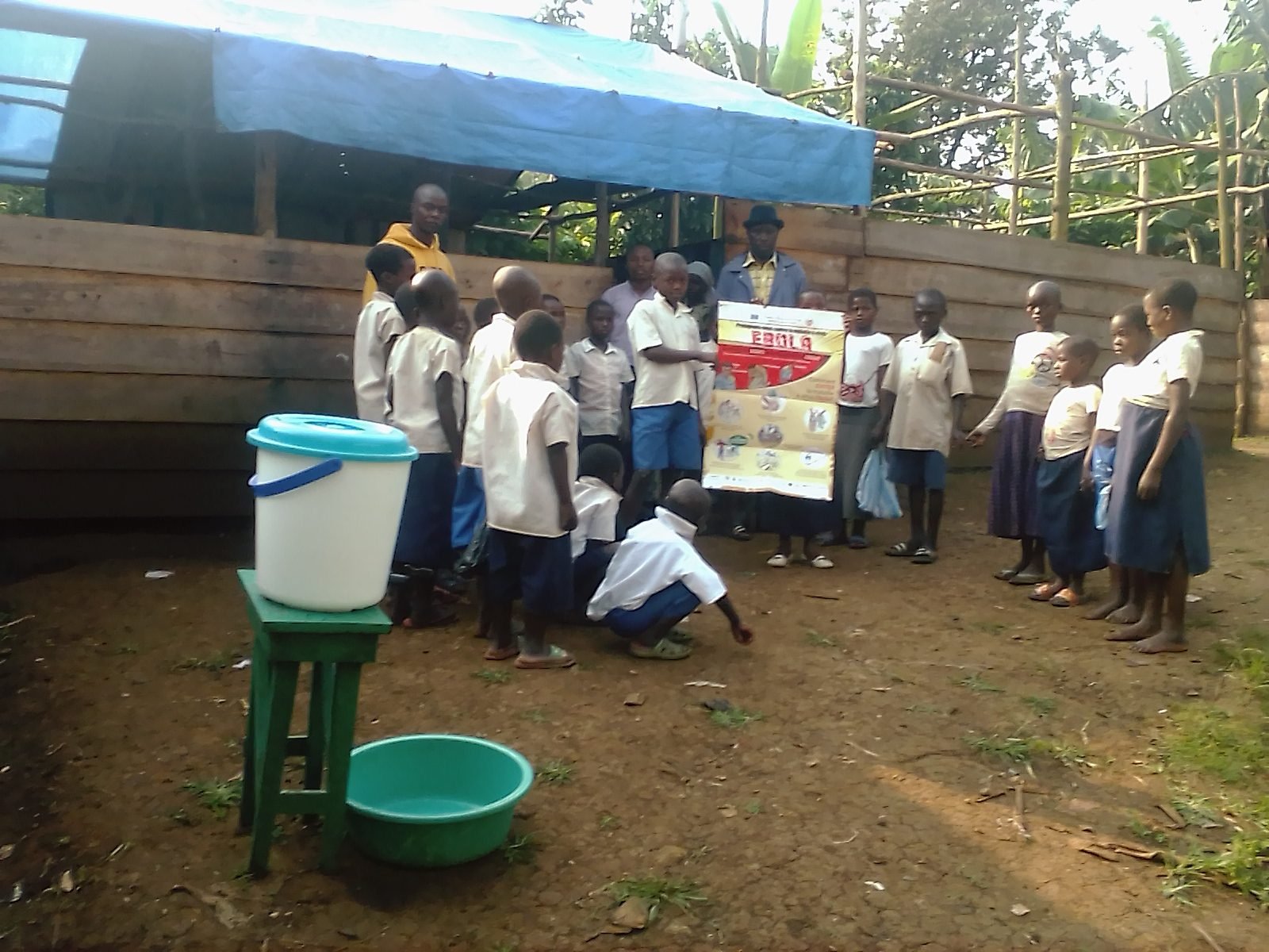 A school hygiene lesson beside a handwashing station