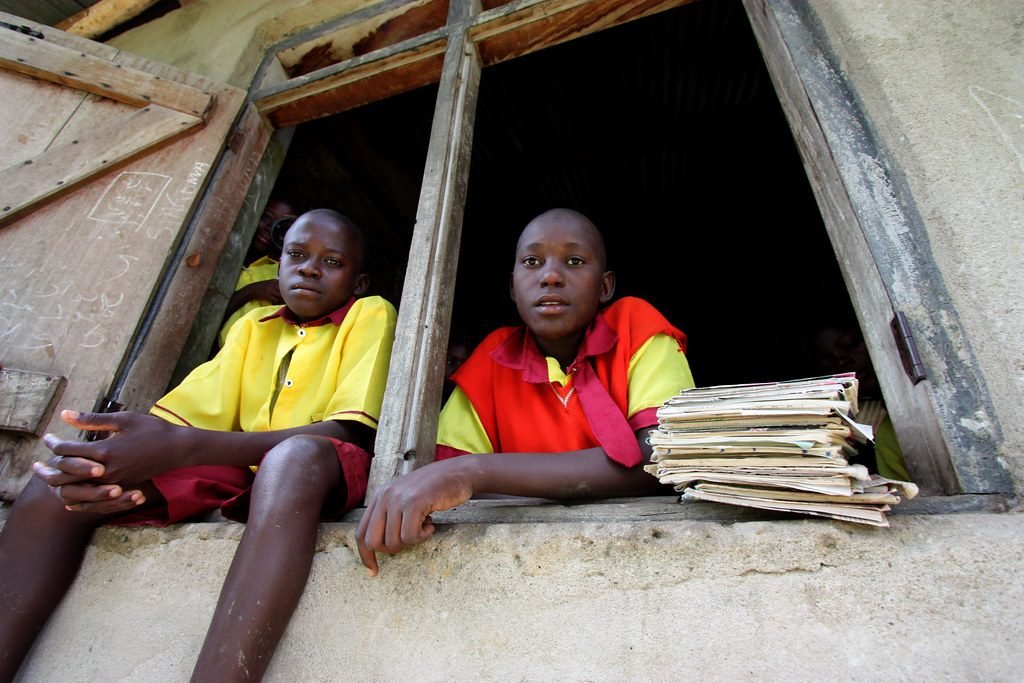 Two students with a stack of books at their school in the DR Congo