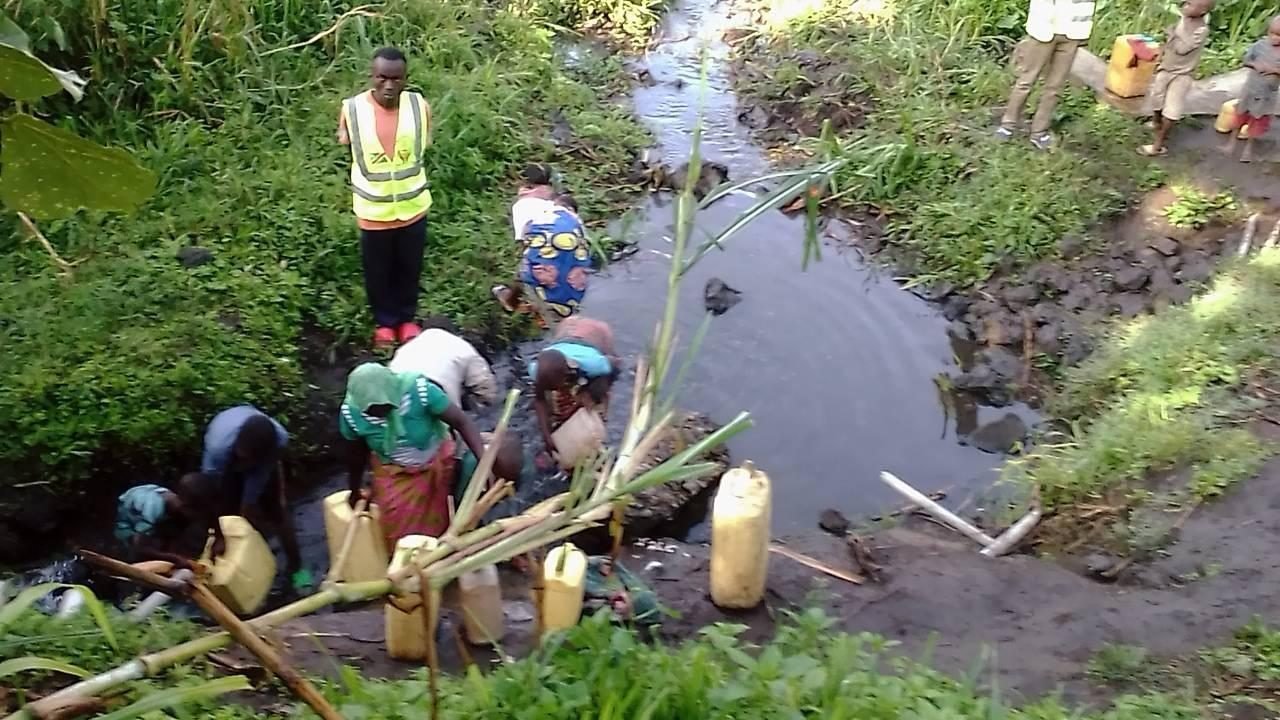 People collecting water from a stream in North Kivu, DR Congo