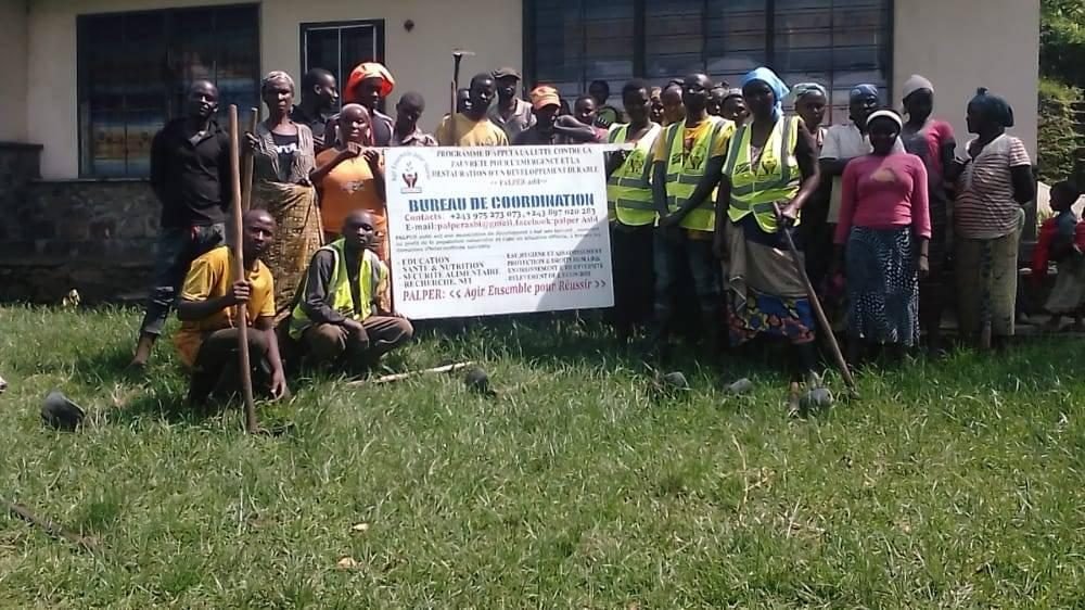 A community work team in high-visibility vests with the PALPER banner in North Kivu, DR Congo