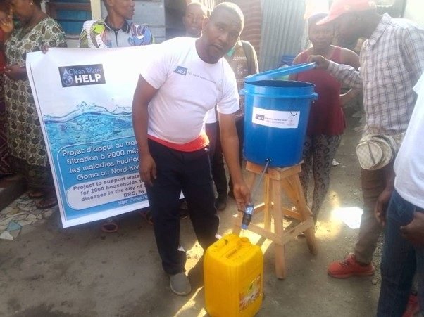 Martin Mashagiro, President of PALPER asbl, drawing treated water from a household filter station in Goma, DR Congo
